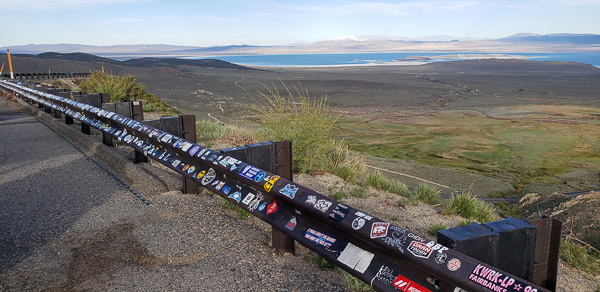 Stickers on guard rail at Consway summit view point and Mono Lake in the distance